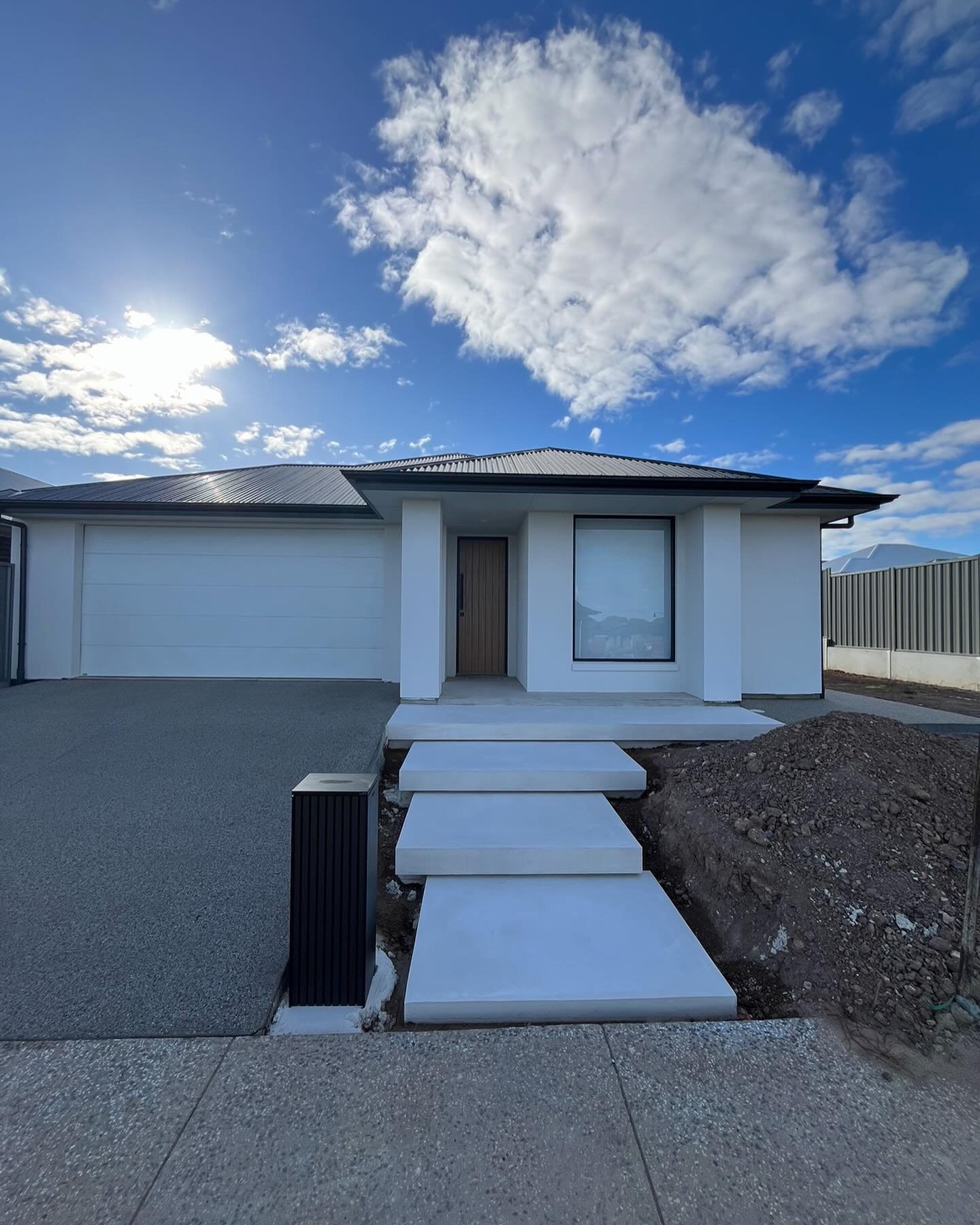 Modern Adelaide home with concrete driveway and steps